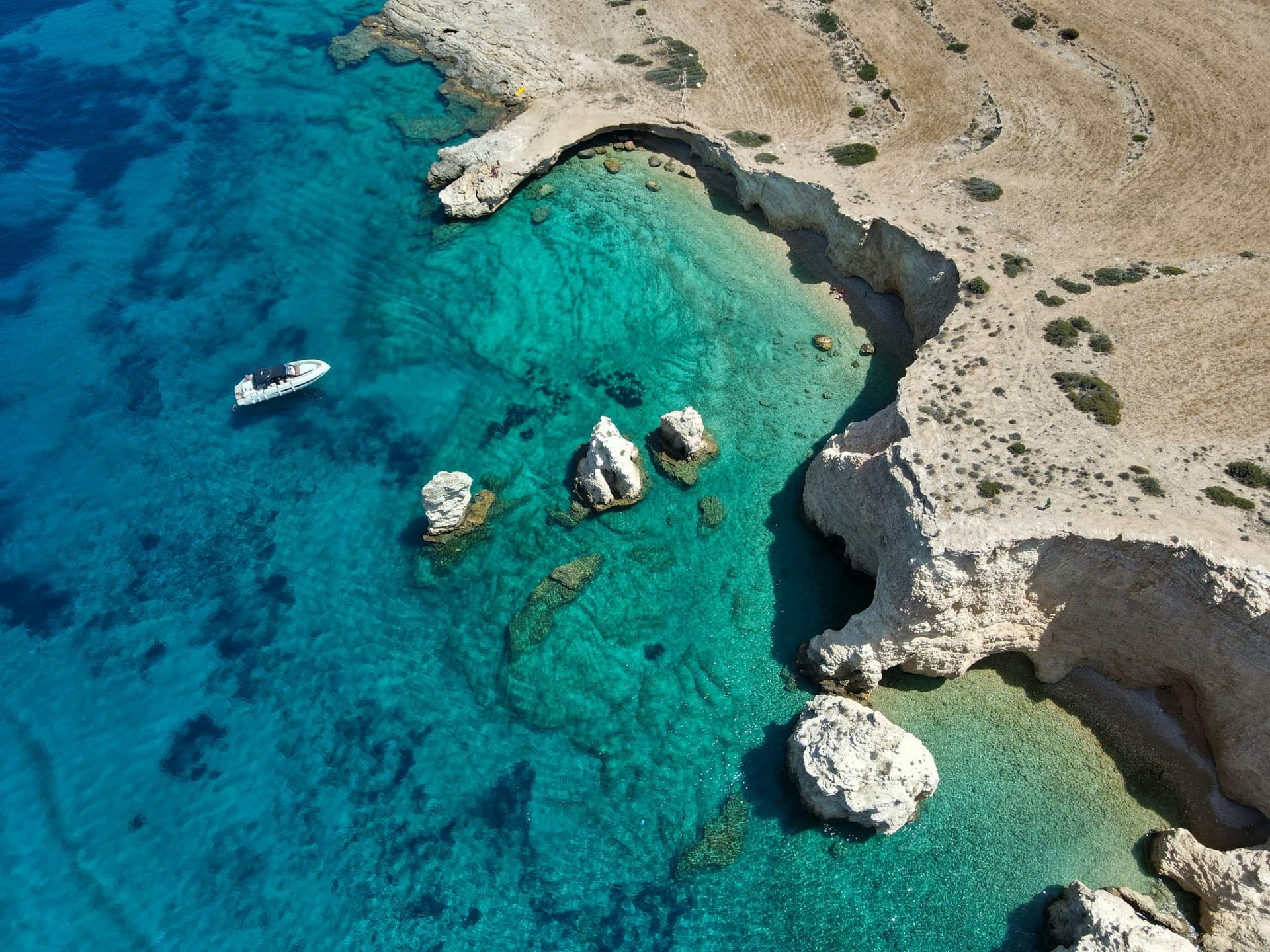 Koufonisia turquoise cove with a private yacht
