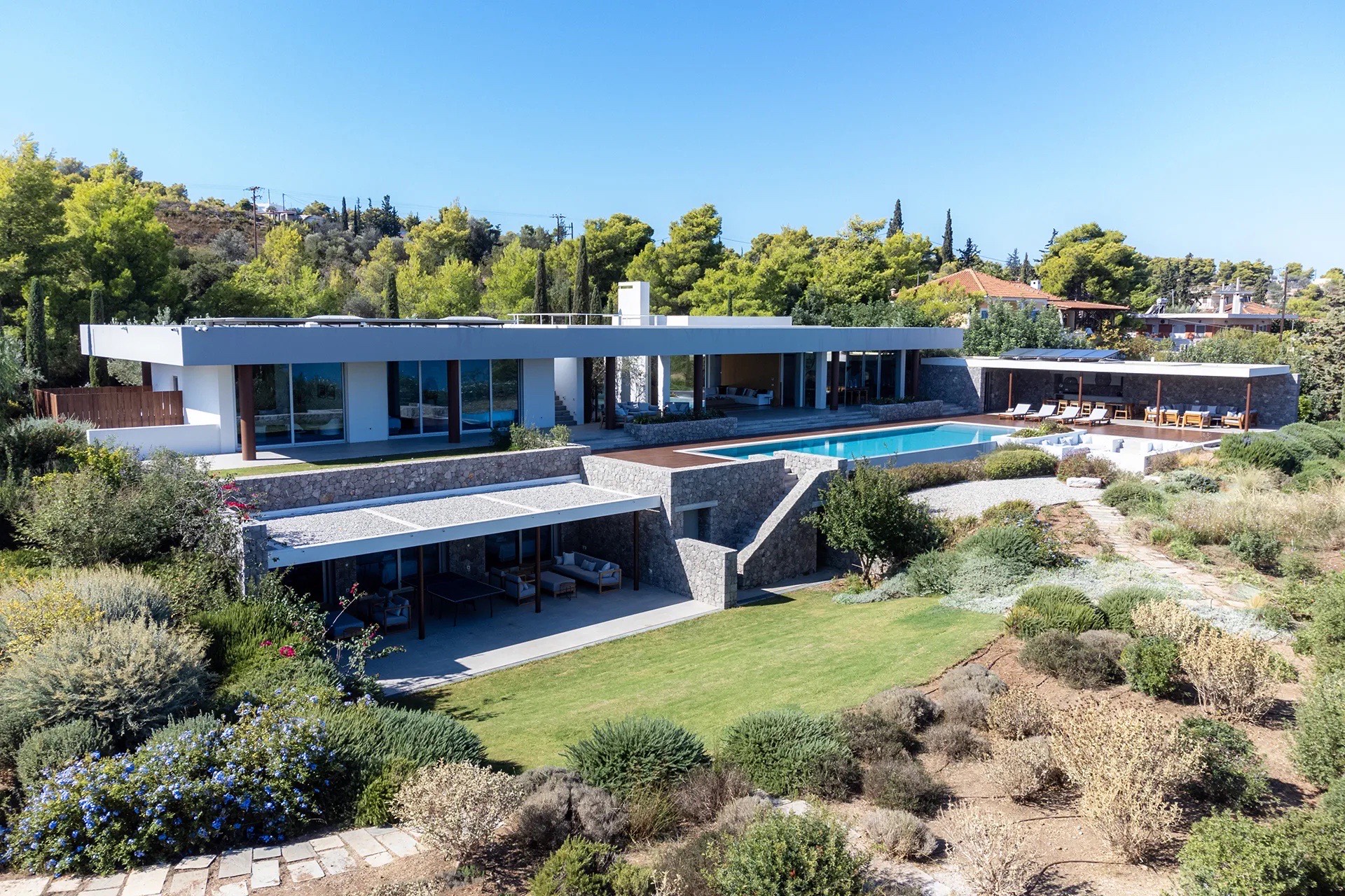 Aerial of the residence above the bay, infinity pool and gardens
