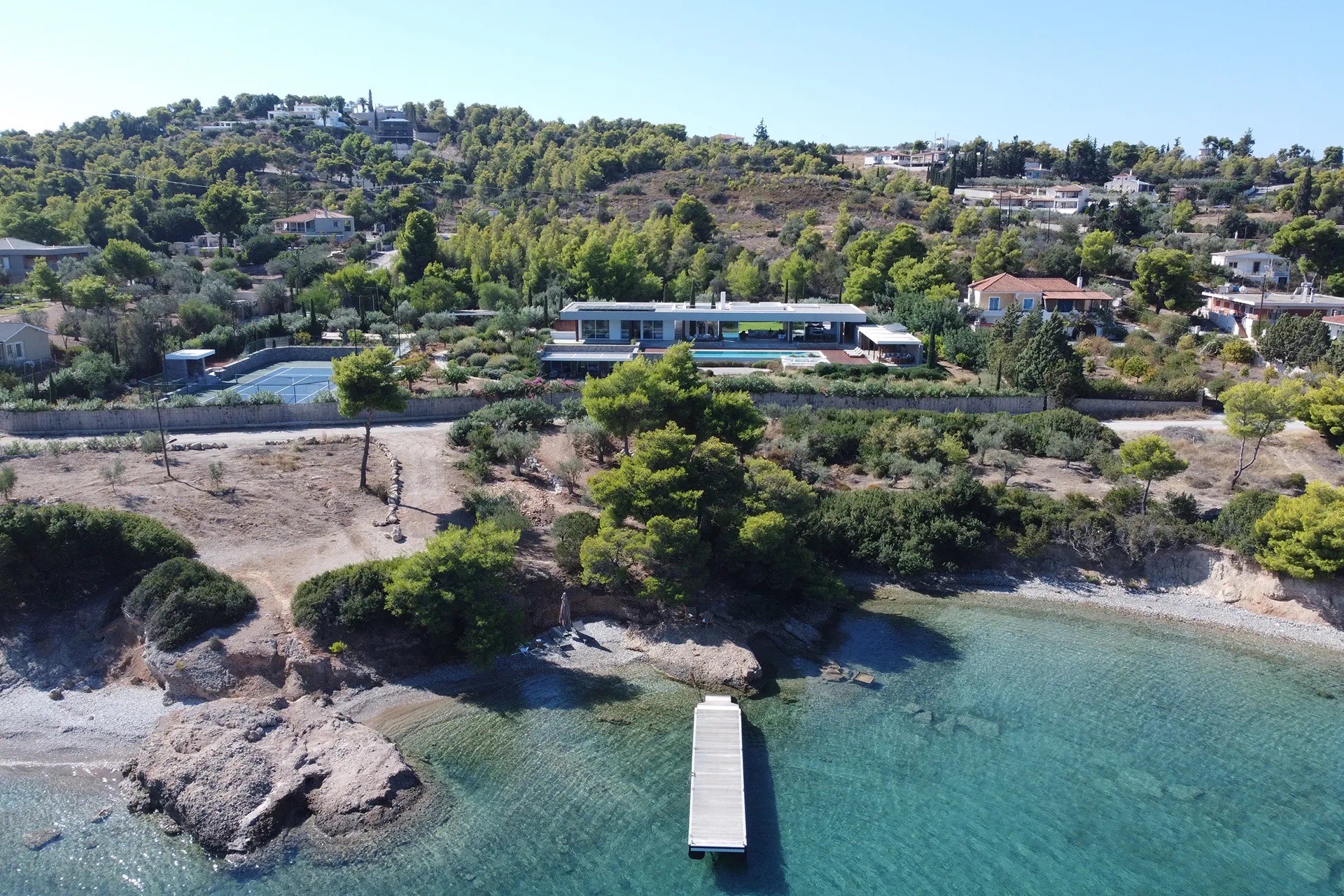Pool deck and lounges seen from above, sea beyond