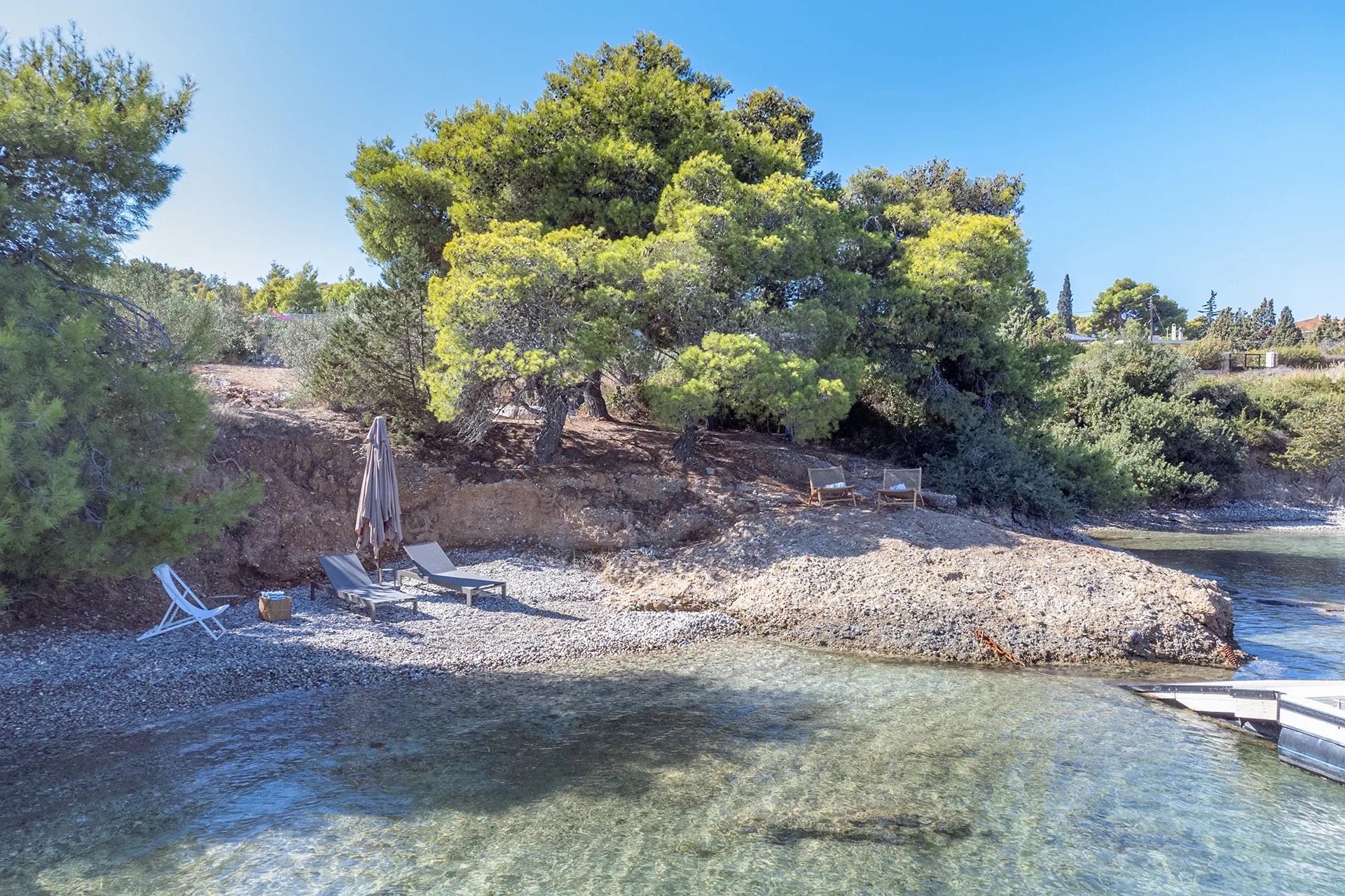 Pool side of the villa, open-plan living facing the water
