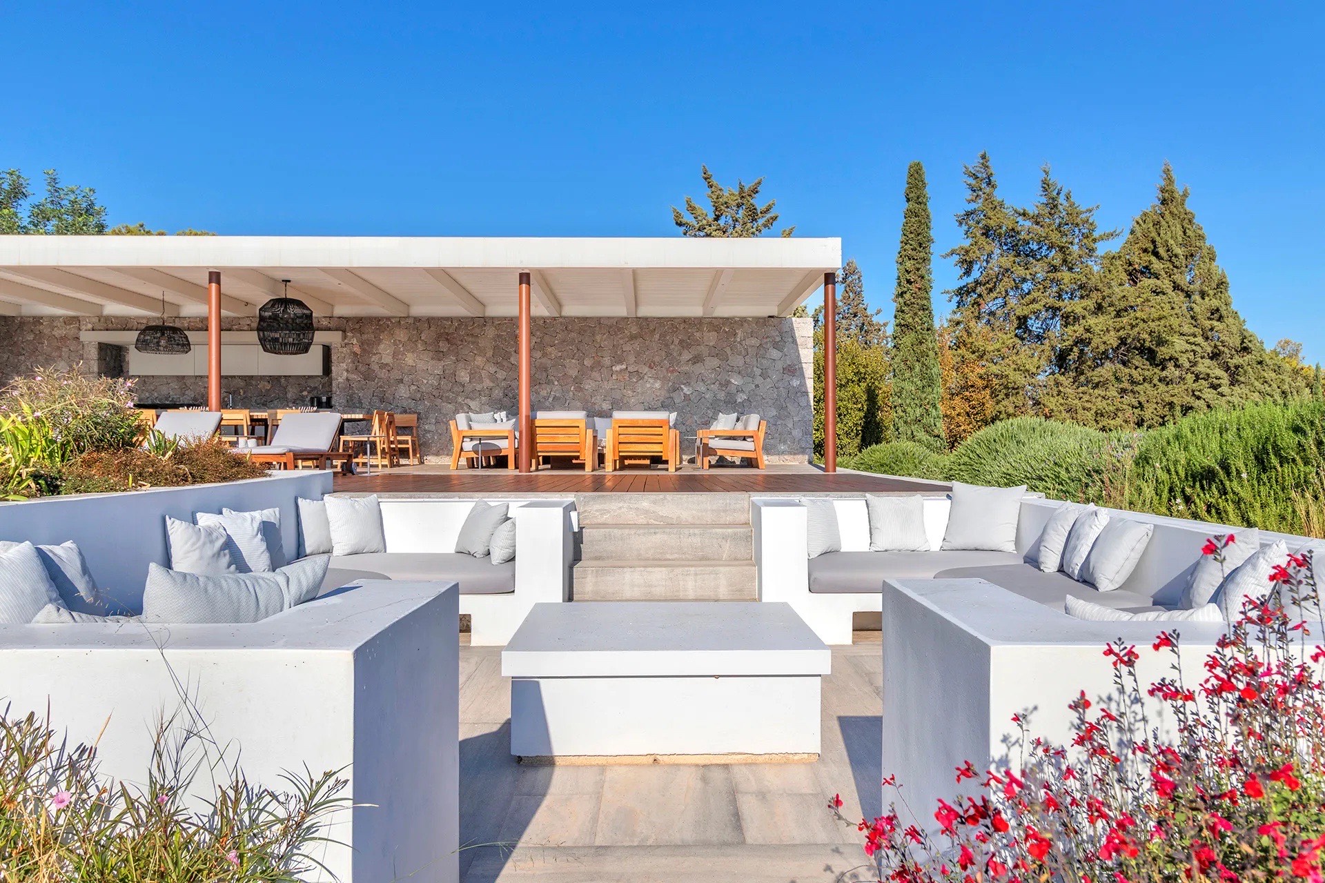 Australian-surface tennis court framed by pines