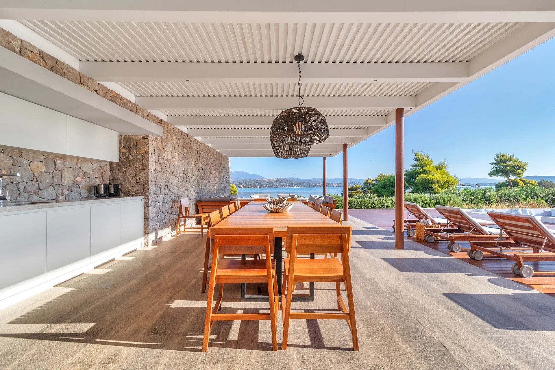Living room with fireplace, glass walls onto the pool