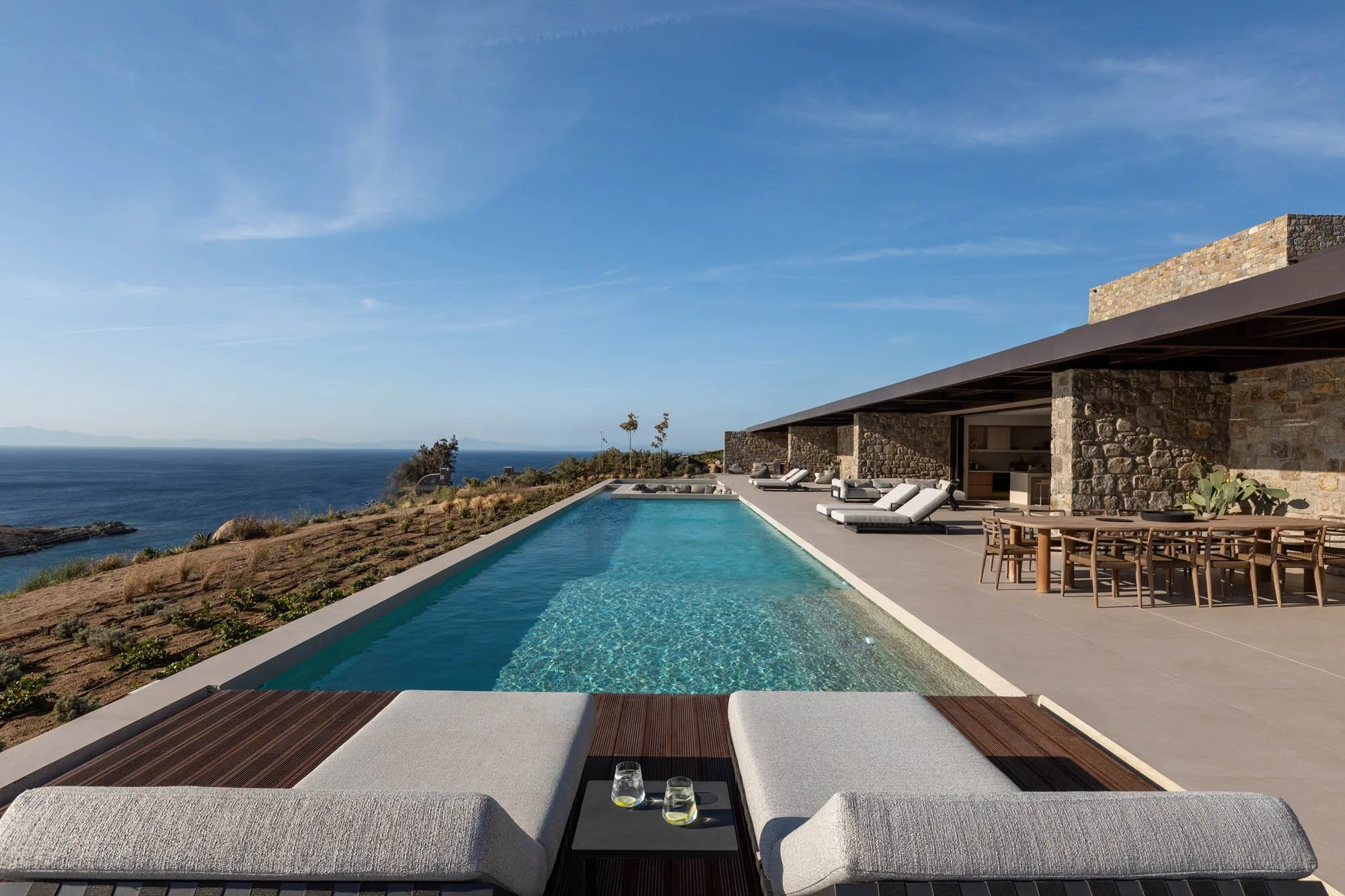Long infinity pool opening onto the Aegean