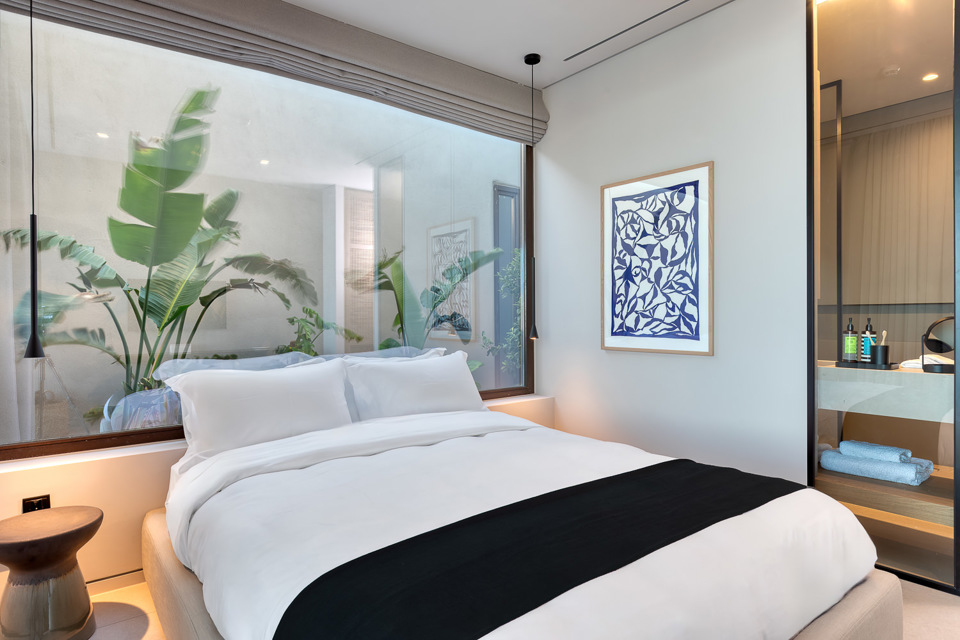 Bedroom with garden view through glass