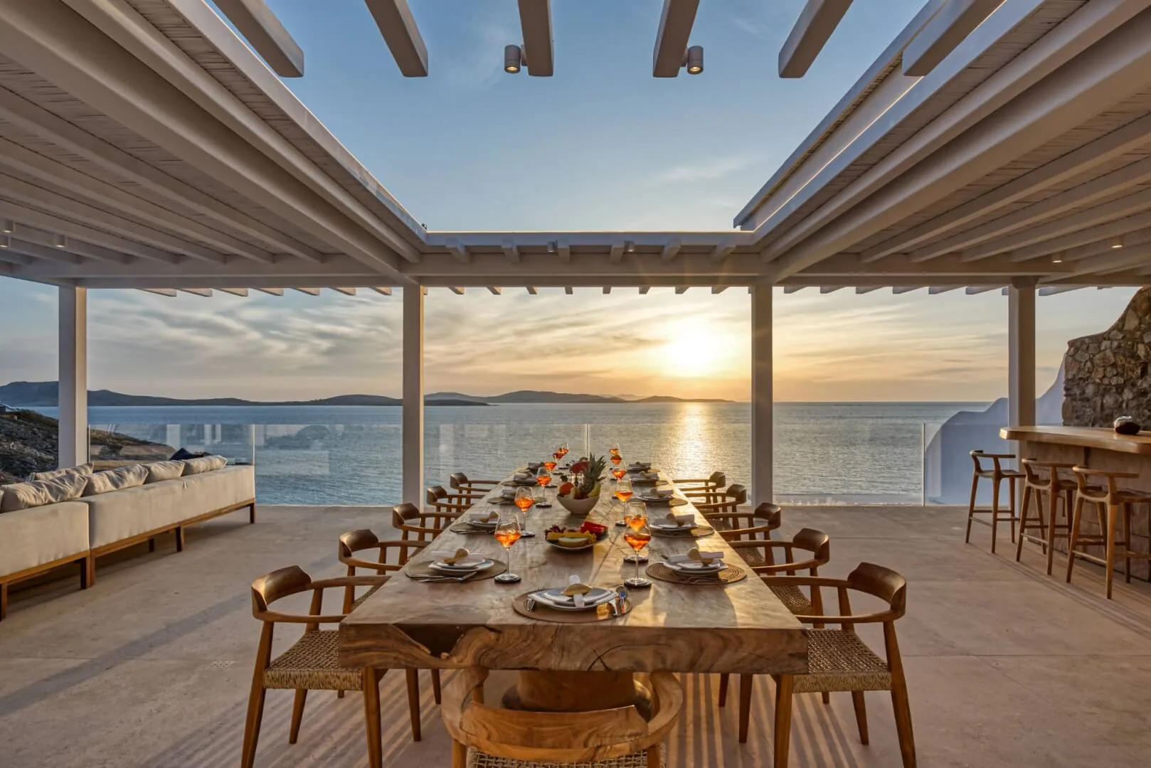 Alfresco dining table set under the pergola at sunset