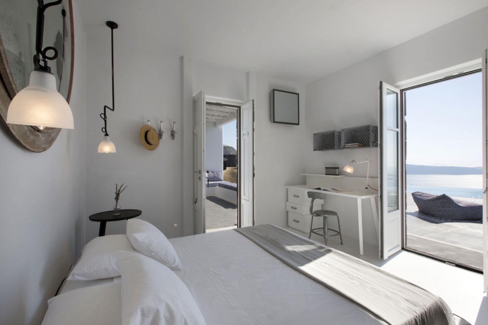 White Cycladic suite, doors open onto a private terrace and the sea