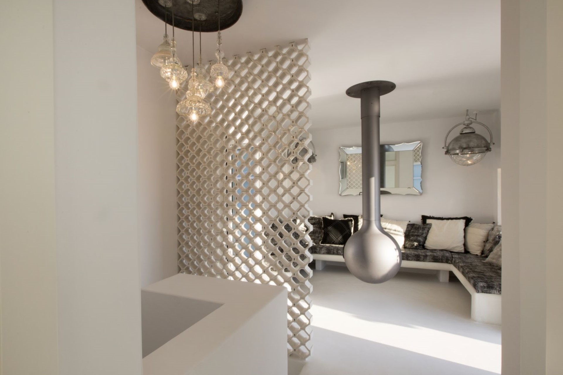 Living room with sculptural latticed screen and floating fireplace