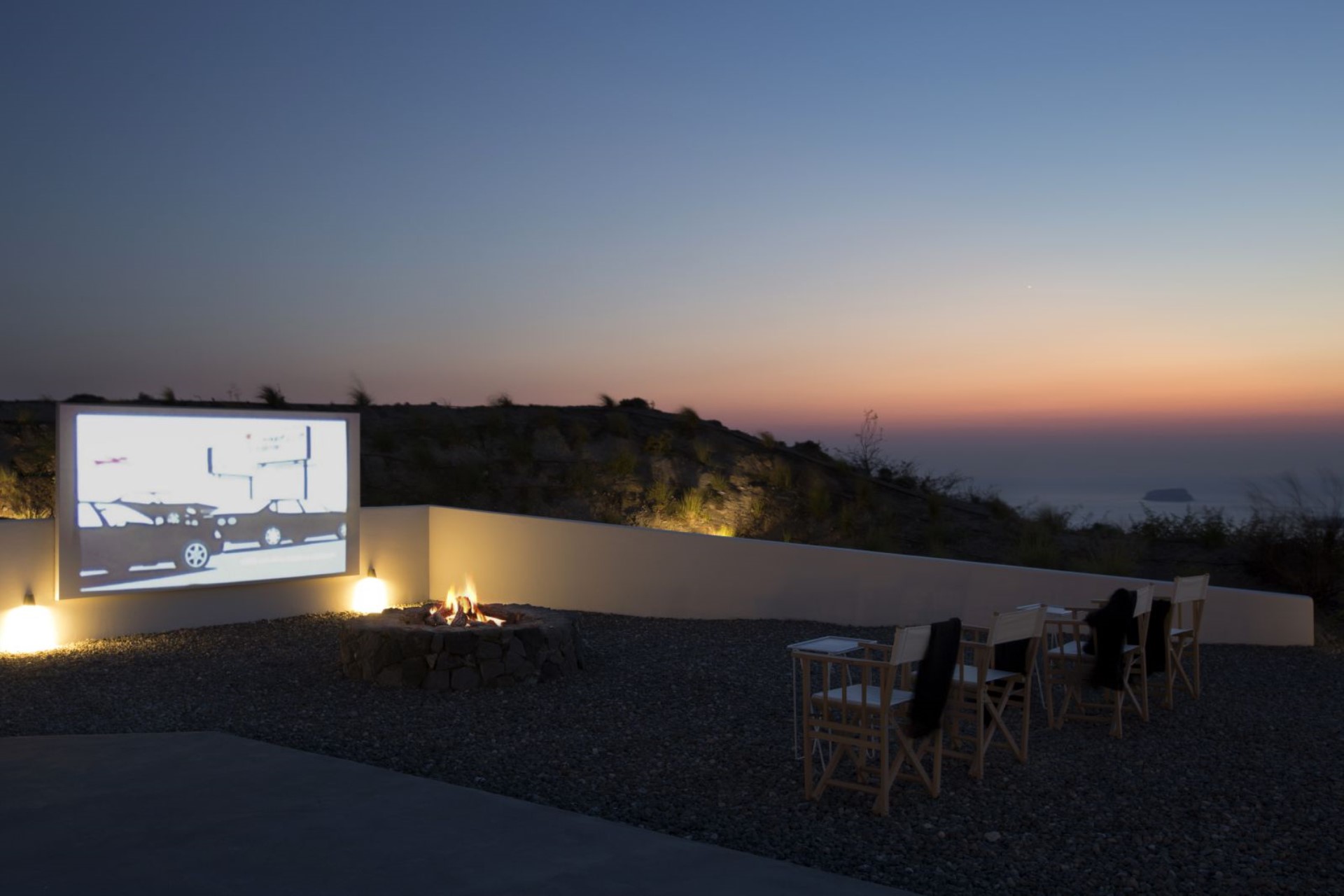 Outdoor cinema and firepit at sunset, the Aegean beyond