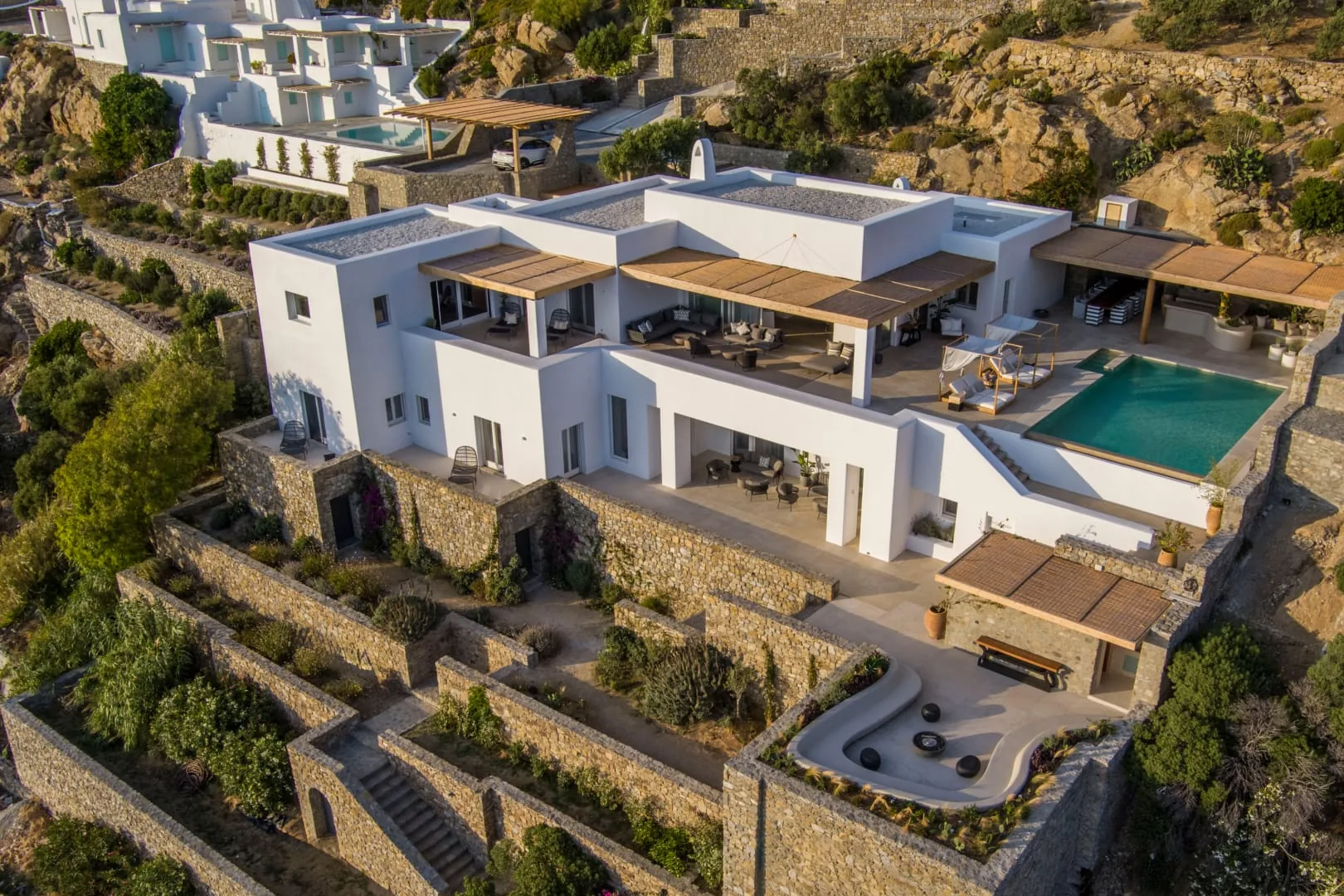 Aerial of the villa cascading down the Tourlos hillside