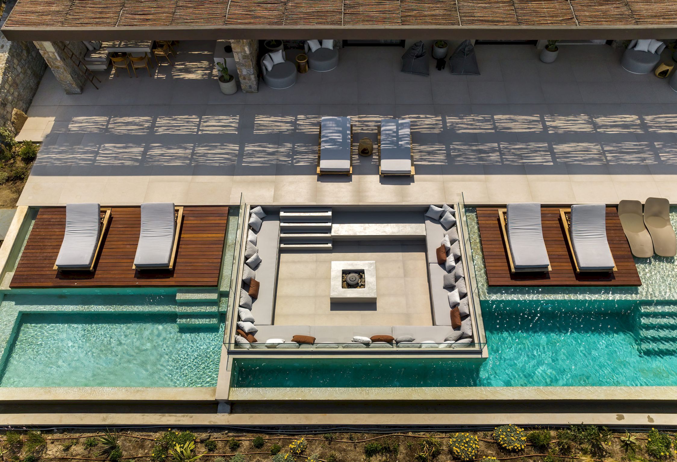 Aerial view of twin pools and central sunken lounge with fire pit