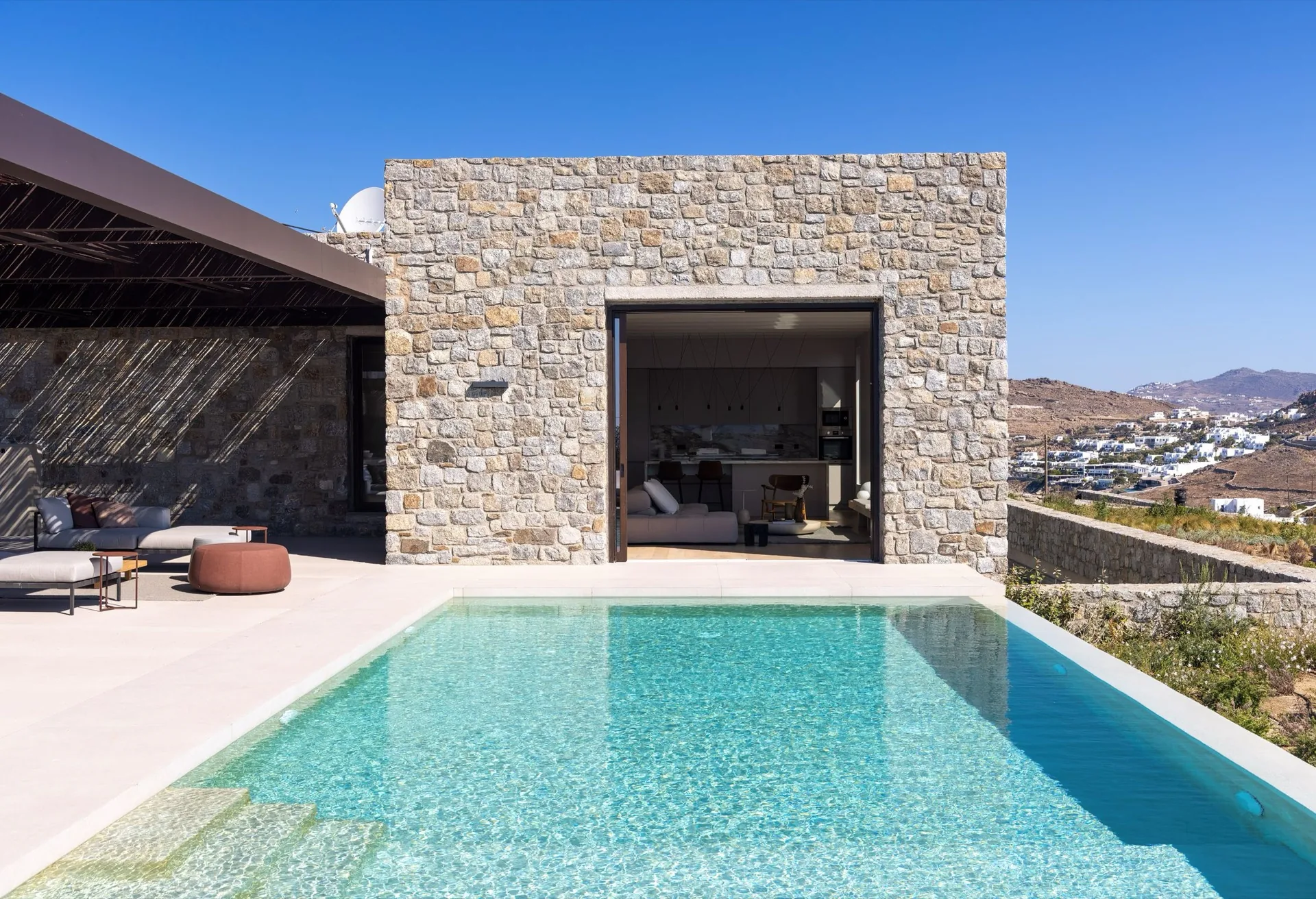 Stone guest pavilion beside the pool