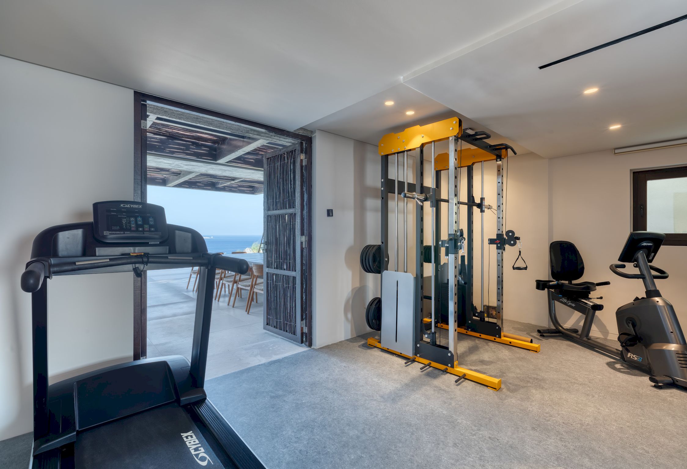 Private gym opening onto the terrace and the sea