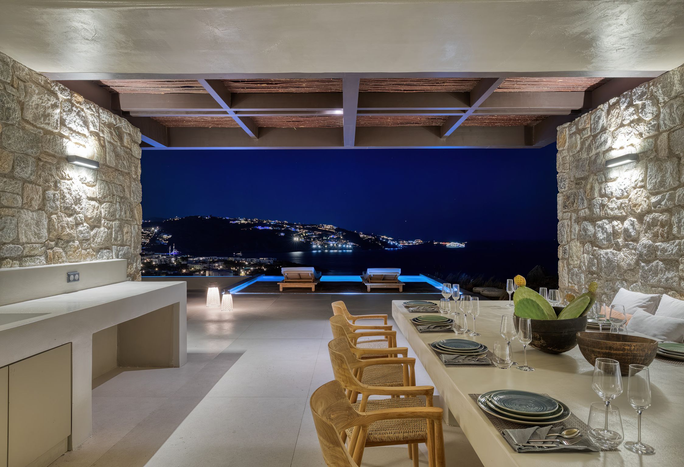 Evening dining bar overlooking Mykonos harbour lights