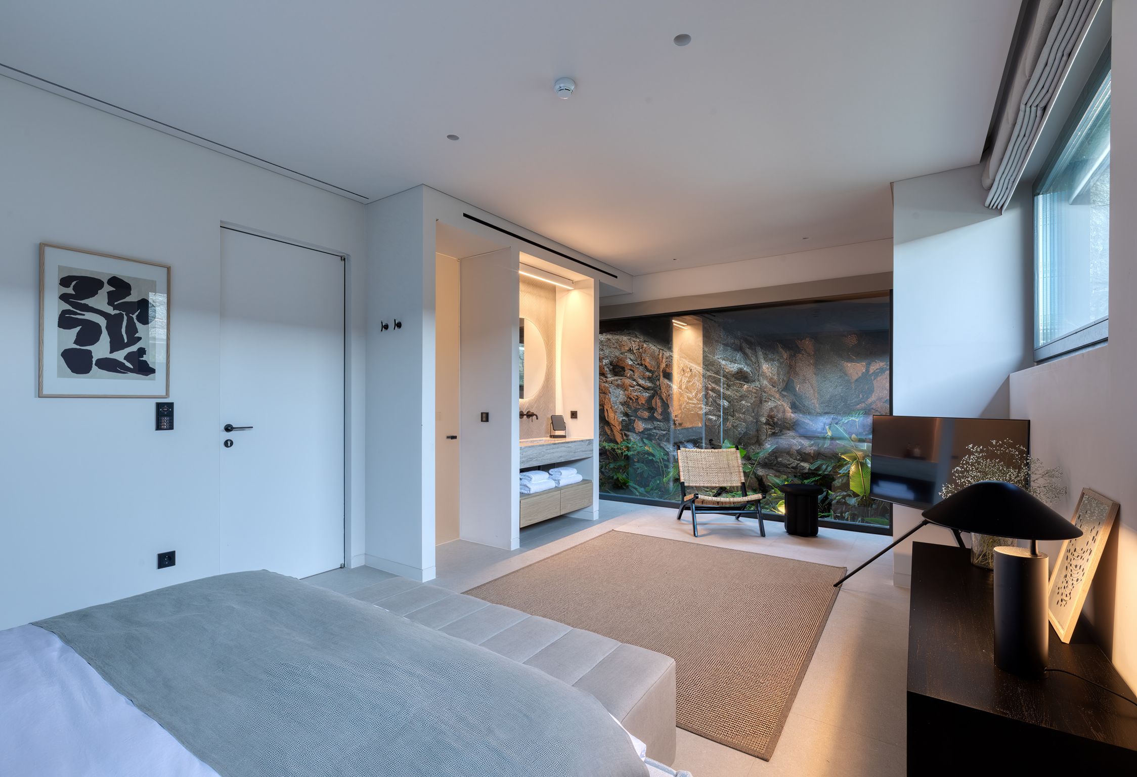 Bedroom opening onto a private patio carved into the rock