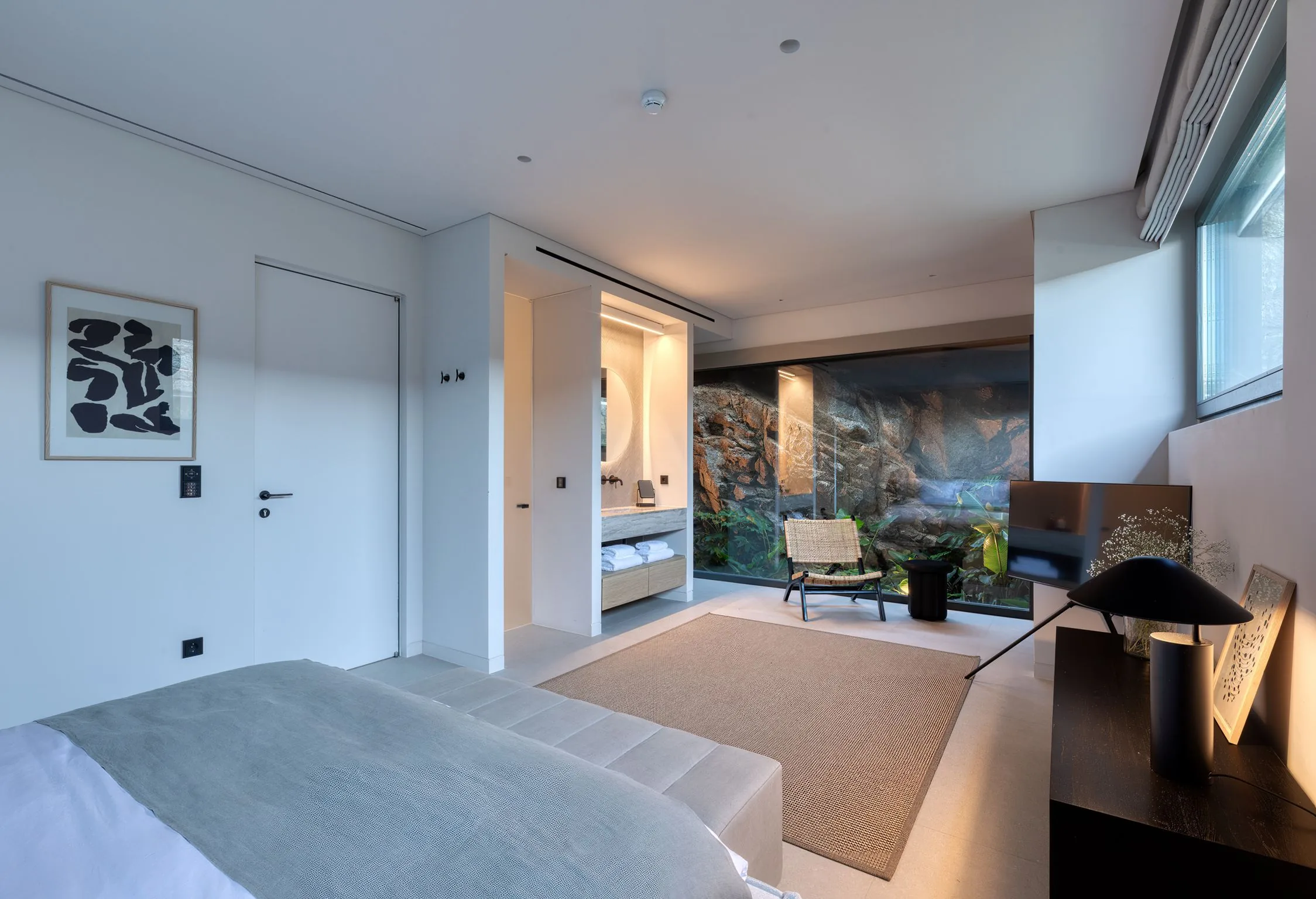 Bedroom opening onto a private patio carved into the rock