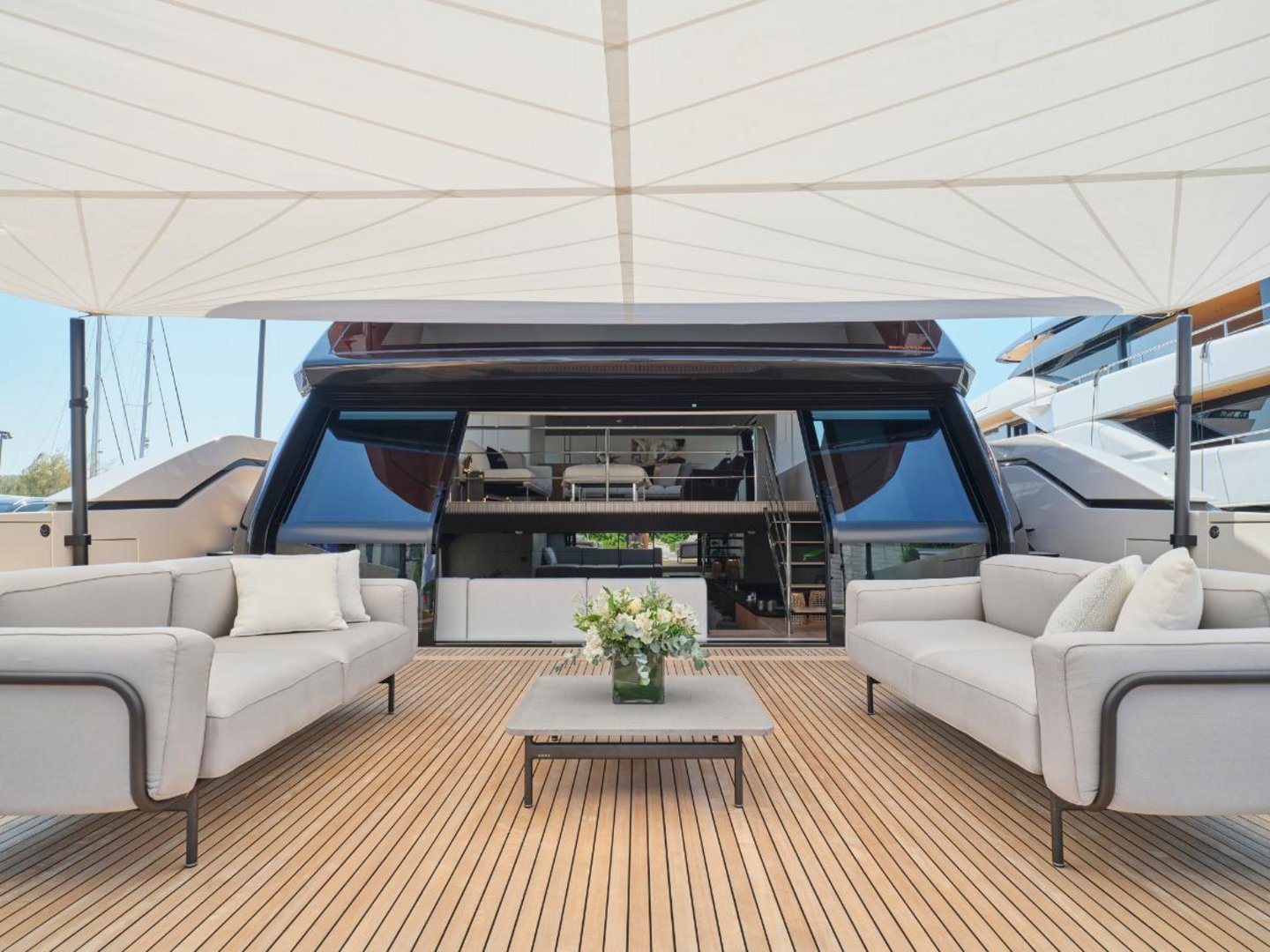 Aft deck lounge with sofas, the open sea behind